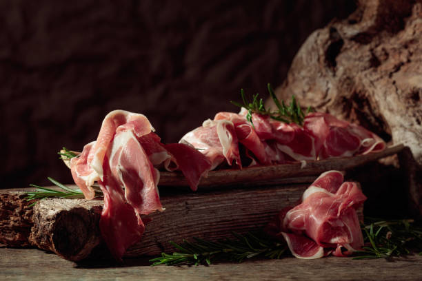 istock Italian prosciutto crudo or Spanish jamon with rosemary. 2159133165