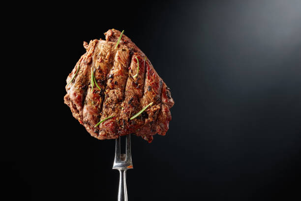 istock Grilled ribeye beef steak with rosemary on a black background. 2159133176