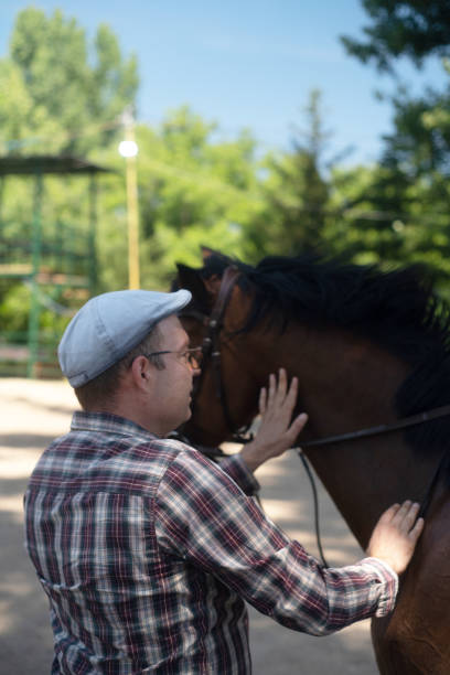 istock Handsome man portrait with a horse stallion 2159133663