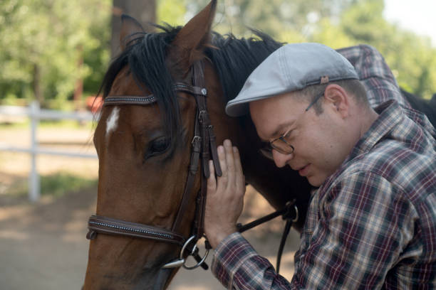 Handsome man portrait with a horse stallion .