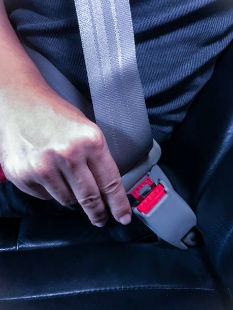 istock Hand wearing a car seat belt 2159135020