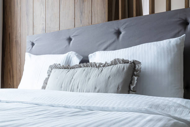 istock White and gray soft pillows on the bed 2159135180