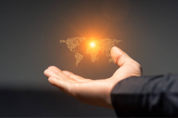istock Artificial intelligence world map symbol and hand holding it on dark 2159137989