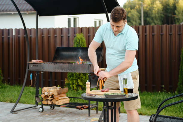 istock Man making barbecue outdoor 2159138473