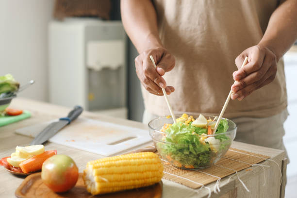 istock Man Making Salad In The Morning 2159141495