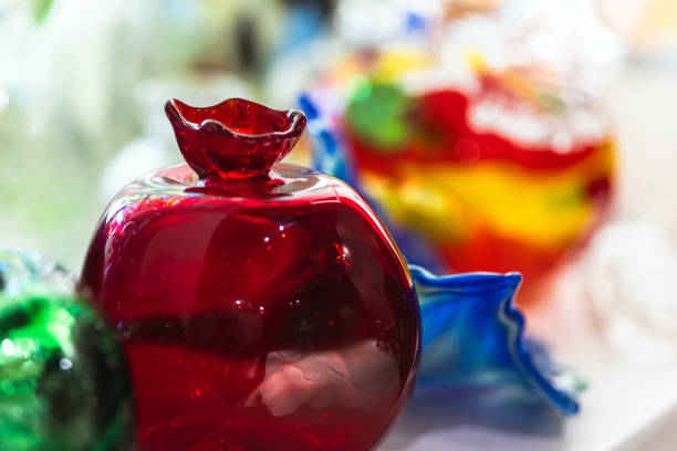 Close-up of handcrafted lead glass art from Karlovy Vary, Czech Republic. The image showcases vibrant, textured patterns and brilliant colors typical of traditional Bohemian crystal craftsmanship.