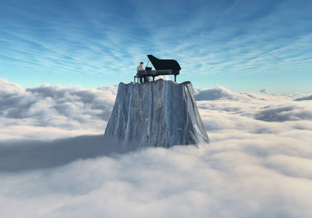 istock Man playing the piano on a rock above the clouds. 2159142190