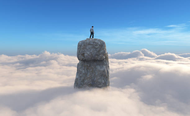 istock Man on top of a rock above the cloud ceiling. 2159142200