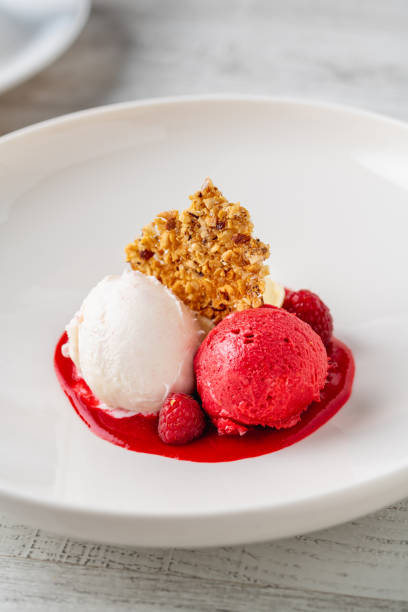 istock Raspberry and cream ice cream in a white porcelain bowl 2159143568