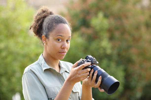 istock Serious black photographer looks at you 2159143971