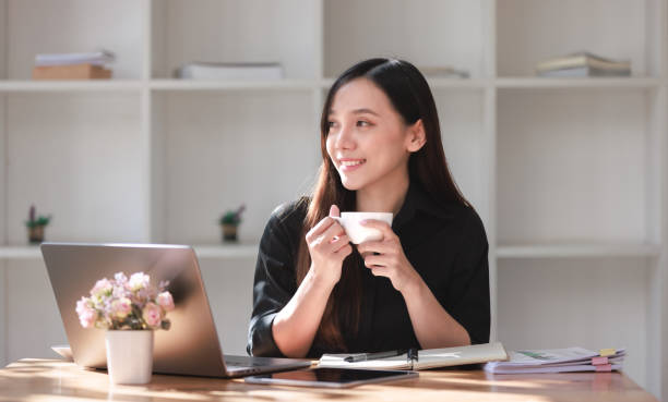 istock Beautiful Young Woman working in workspace with Smartphone and Laptop 2159144921