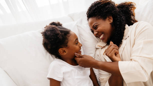 istock Mother and daughter bonding together in bed 2159145207