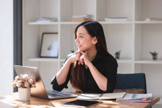 istock Beautiful Young Woman working in workspace with Smartphone and Laptop 2159145212