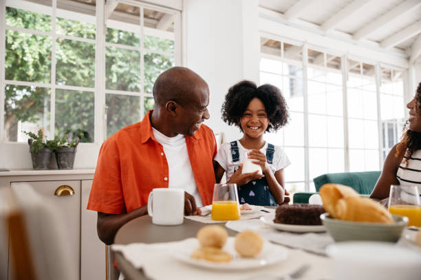 Happy family enjoying breakfast together in bright kitchen
