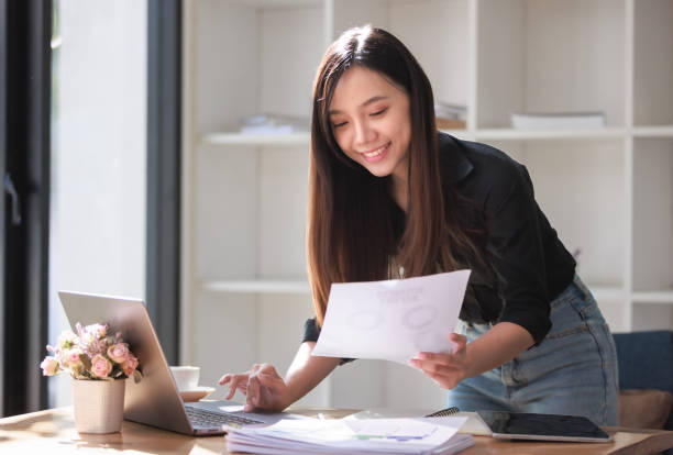 istock Beautiful Young Woman working in workspace with Smartphone and Laptop 2159146087