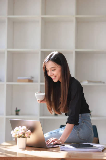 istock Beautiful Young Woman working in workspace with Smartphone and Laptop 2159146227