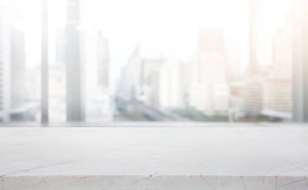 istock Modern marble table top on blur abstract window glass with city town background. 2159149026
