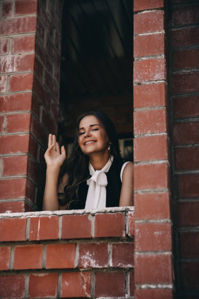 A beautiful woman near a big house