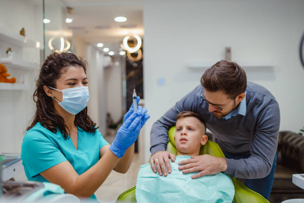 istock Boy with parent and dentist preparing for dental injection 2159150272