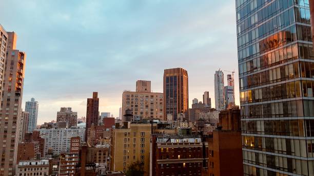 istock Beautiful sunset in downtown nyc seen from a rooftop bar 2159150449