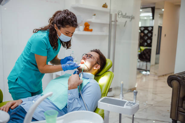 istock Professional female dentist examining patient’s teeth 2159150471