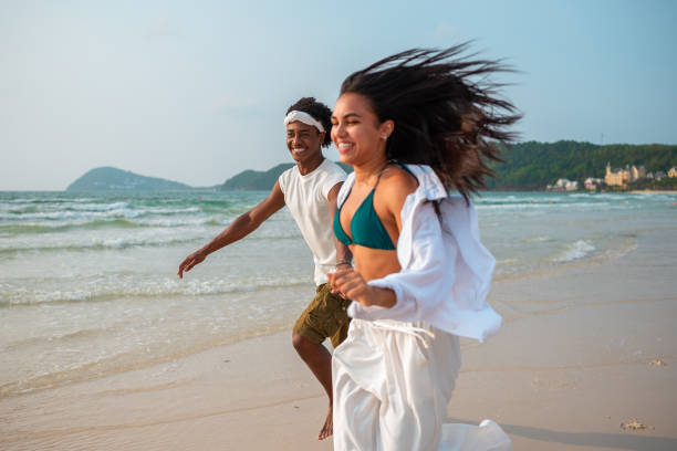 istock Joyful Couple Running on Beach 2159151442