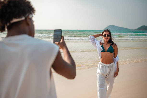 istock Man Photographing Woman at Beach 2159151491