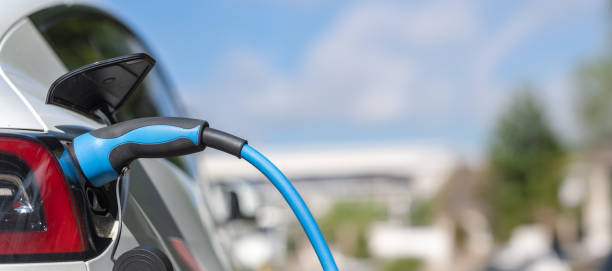 istock Electric Car Charging in Sunlight – Sustainable Mobility 2159151721