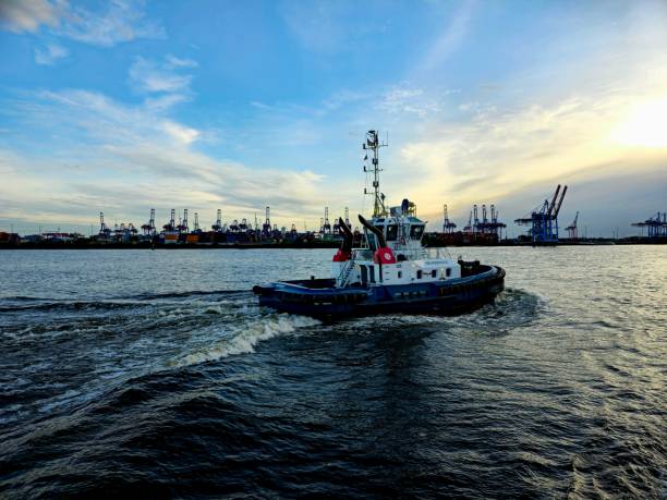 Tugboat at Port of Hamburg. The image shows a Tugboat on the River Elbe, captured during speing season.