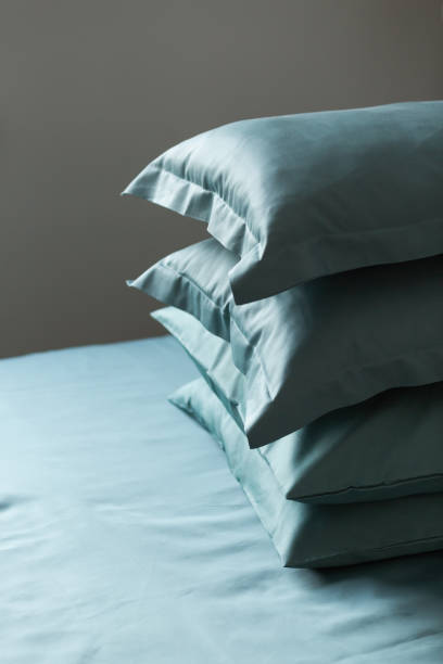 istock Turquoise satin (lyocell, silk, polyester) pillowcases on the bed. Home textile. 2159153970