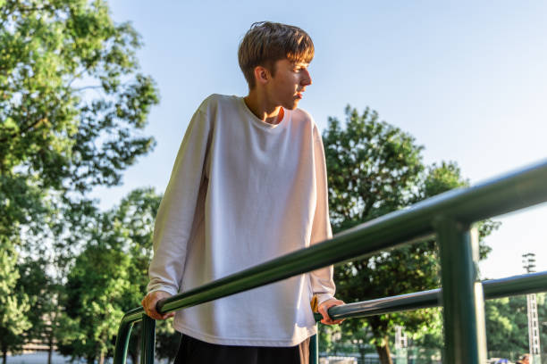 istock Young Man Performing Dips Exercise on Parallel Bars at Outdoor Gym 2159155035