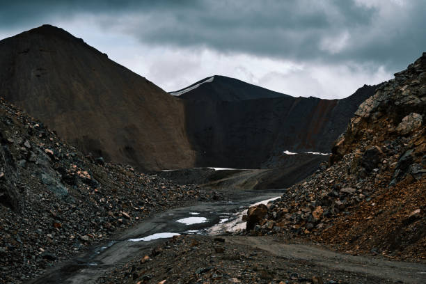 istock Dark peaks of mountain ridge over road through pass saddle under storm clouds 2159155581