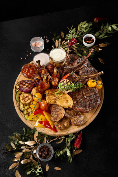 istock Assorted BBQ Meat Feast with Grilled Vegetables on a Summer Evening 2159156759