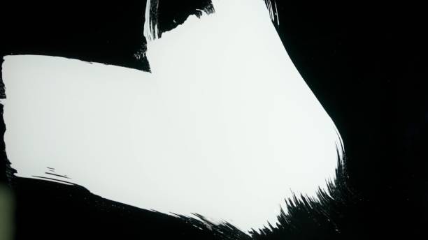 istock Person using large brush with acrylic oil medium white paint and drawing stroke directly on black glass screen isolated background, opposite view scene. 2159159513