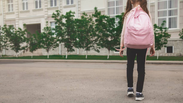 istock Back to school. cute child girl with backpack going to school 2159160065