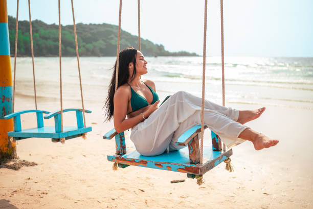 istock Relaxed Hispanic Woman Enjoying Beach Swing 2159160351