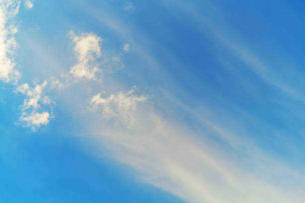 Developing in a plume of the upper layers of the atmosphere of finely dispersed particles with small clouds against the background of a blue sky. Weather Phenomena.