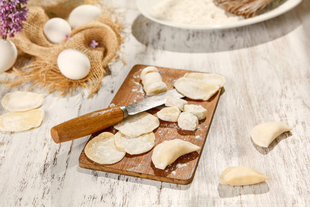 istock Sunlit Kitchen Eggs, Dough, and Flour on Wooden Board in Rustic Setting 2159161392