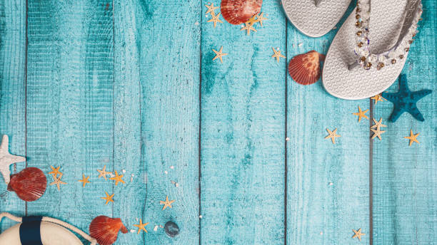 istock Top view composition of sunglasses and flip flops placed on blue background and starfish representing summer vacation on beach 2159161422