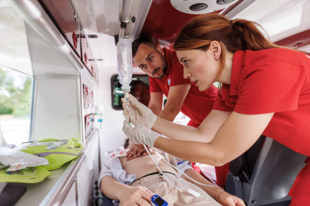 Paramedics providing emergency medical care inside ambulance