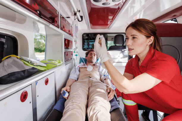 istock Paramedic assisting injured man inside an ambulance 2159164122