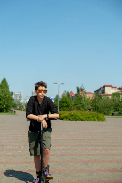 istock Young guy riding on  electric scooter 2159164212