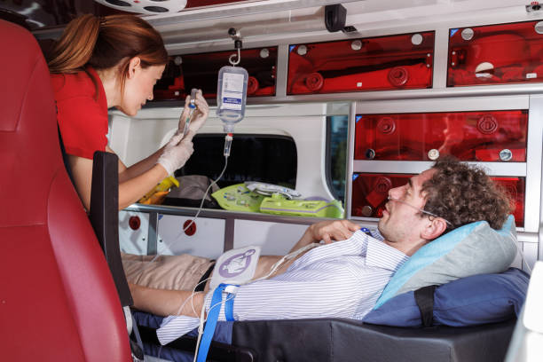 istock Paramedic assisting patient inside ambulance during emergency 2159164286