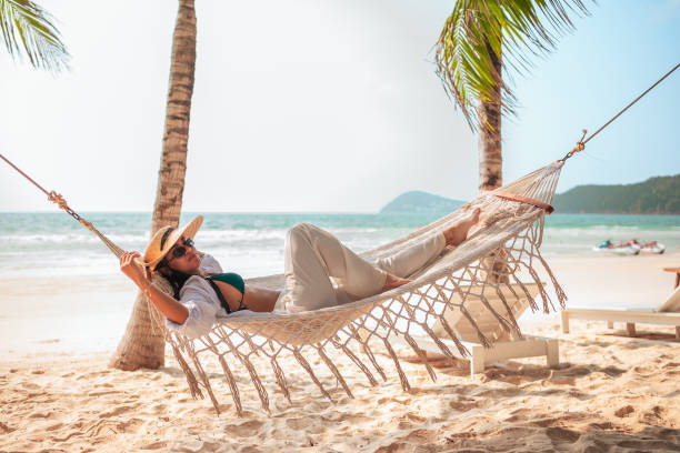 istock Relaxed Hispanic Woman Enjoying Hammock on Tropical Beach 2159165019