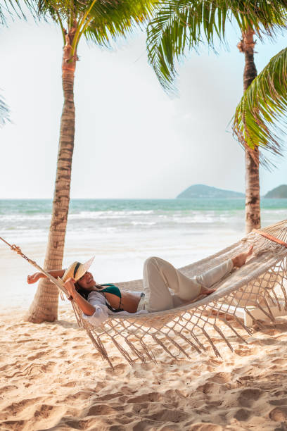 istock Hispanic Female Relaxing in Hammock on Tropical Beach 2159165052