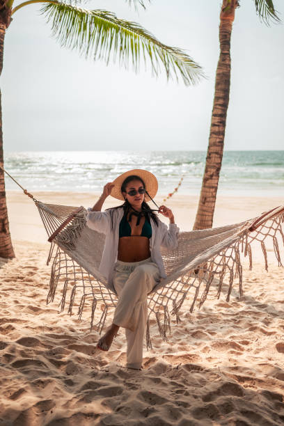 istock Relaxed Hispanic Woman Enjoying Beach Hammock Time 2159165055
