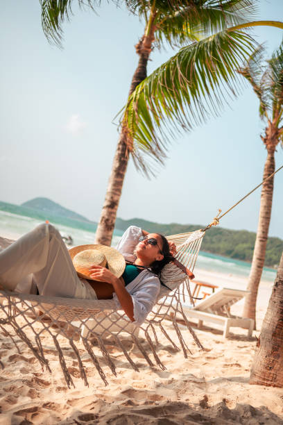 istock Relaxed Hispanic Female Enjoying Hammock on Beach 2159165060