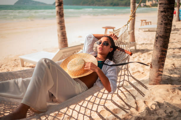 istock Hispanic Woman Relaxing in Beach Hammock 2159165062