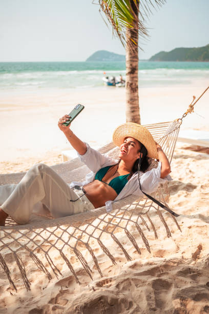 istock Relaxed Hispanic Woman Enjoying Beach Day with Selfie 2159165069