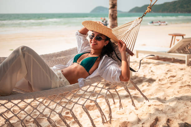 istock Relaxed Hispanic Young Woman Enjoying Hammock on Beach 2159165074